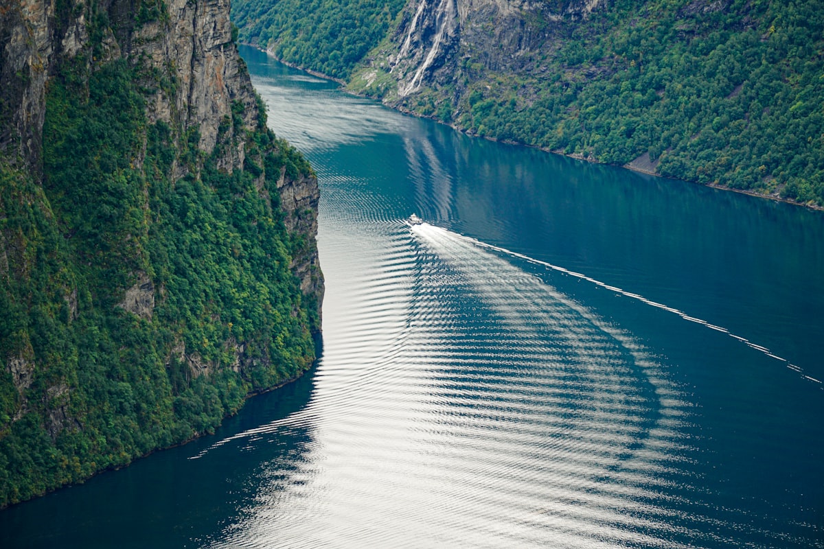 A vessel navigating a Norwegian fjord